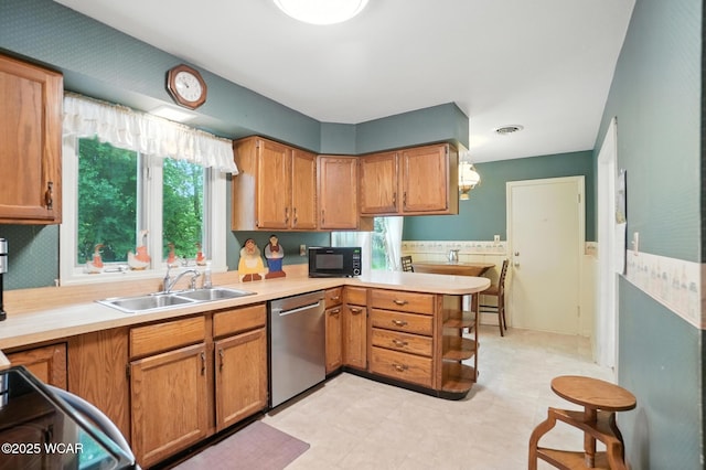 2619 Wendell Ave, Lima, OH 45805 - kitchen featuring stainless steel dishwasher, light countertops, black microwave, a peninsula, and range