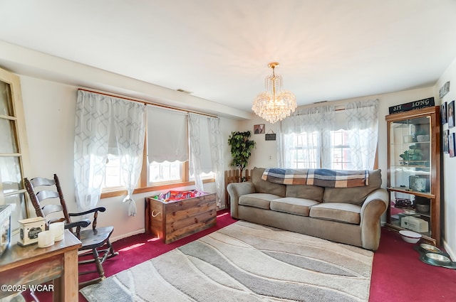 living room with an inviting chandelier and carpet floors