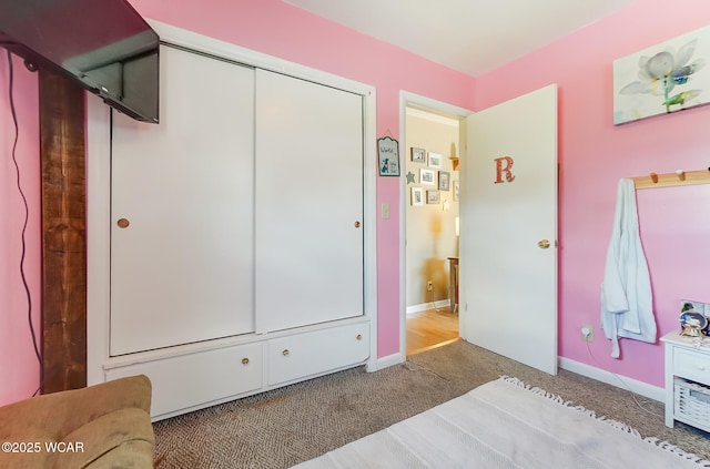 carpeted bedroom featuring a closet