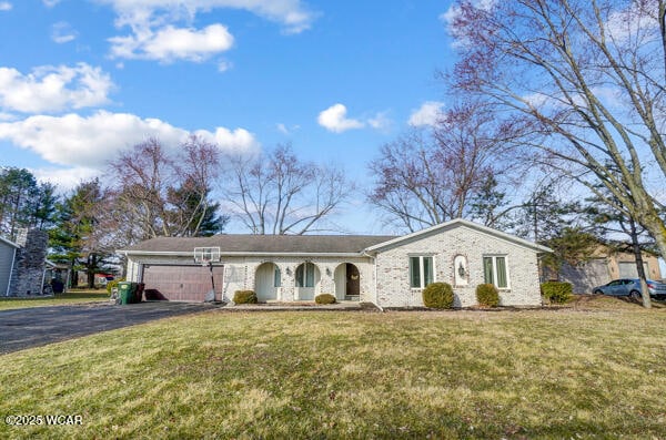1280 Wonderlick Rd, Lima, OH 45805 - ranch-style home with asphalt driveway, a front yard, and an attached garage