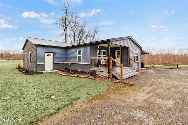 rear view of house with a garage, an outbuilding, and a lawn