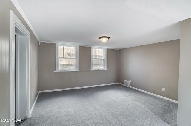 spare room with baseboards, visible vents, and carpet floors