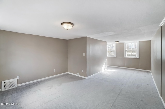 unfurnished room with visible vents, baseboards, and carpet floors