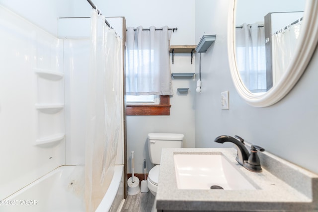 full bathroom with shower / tub combo with curtain, toilet, wood finished floors, and vanity