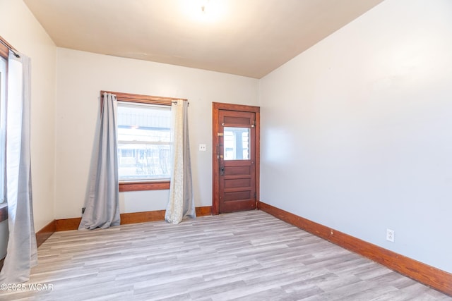 entryway with baseboards and light wood-style floors