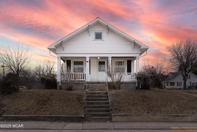 view of front of home with stairway and covered porch