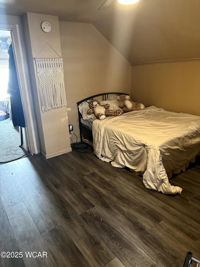 bedroom with lofted ceiling and dark wood-type flooring