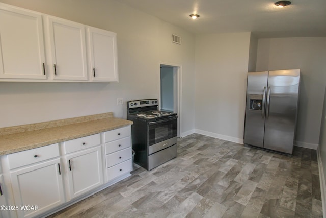 618 N Rosedale Ave, Lima, OH 45805 - kitchen with stainless steel appliances, white cabinetry, light countertops, and baseboards