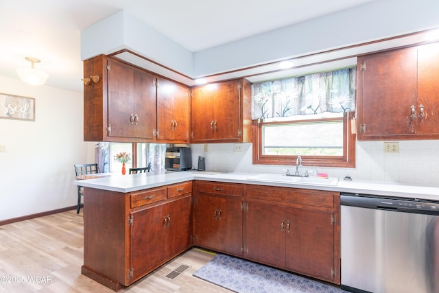 1380 Thomas Rd, New Paris, OH 45347 - kitchen featuring stainless steel dishwasher, a sink, light wood-style flooring, and a peninsula