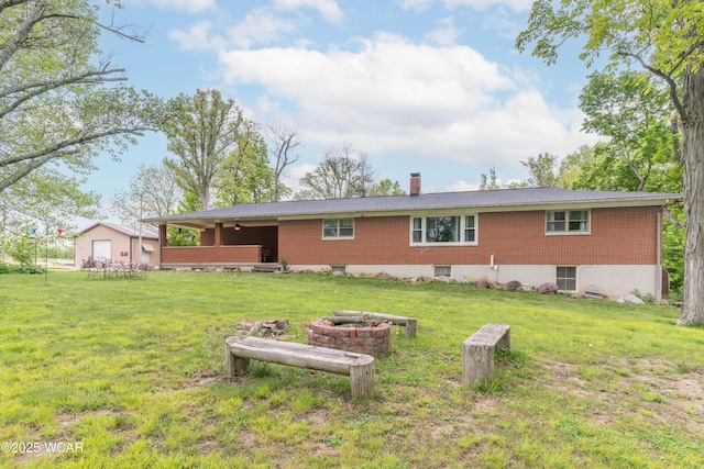 1380 Thomas Rd, New Paris, OH 45347 - rear view of property featuring a yard, a chimney, and brick siding