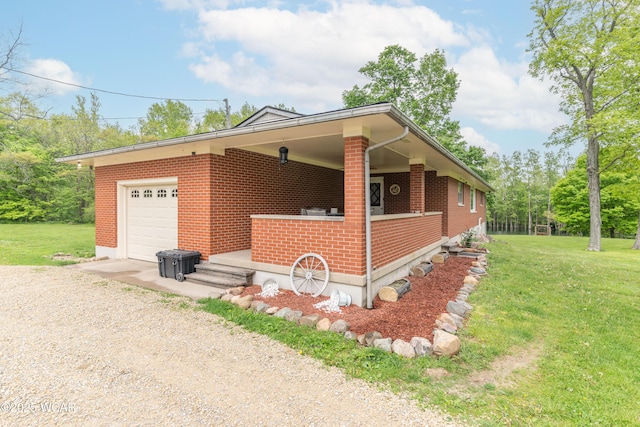1380 Thomas Rd, New Paris, OH 45347 - view of front of home featuring driveway, a front yard, brick siding, and an attached garage