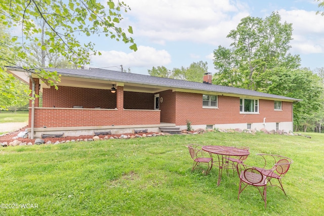 1380 Thomas Rd, New Paris, OH 45347 - back of property with a chimney, brick siding, and a yard