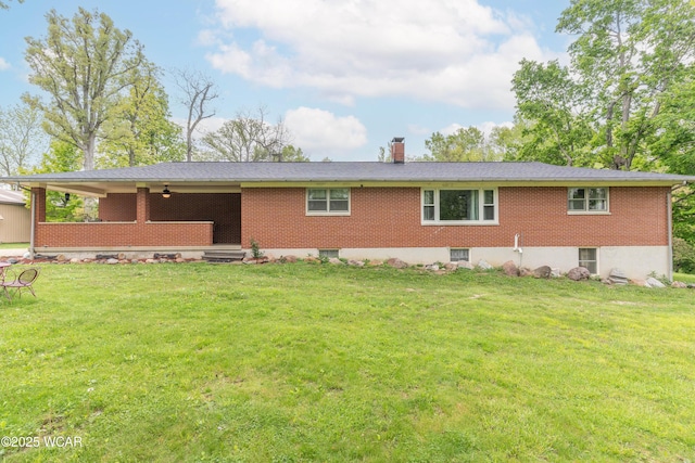 1380 Thomas Rd, New Paris, OH 45347 - rear view of property featuring brick siding, a chimney, and a lawn