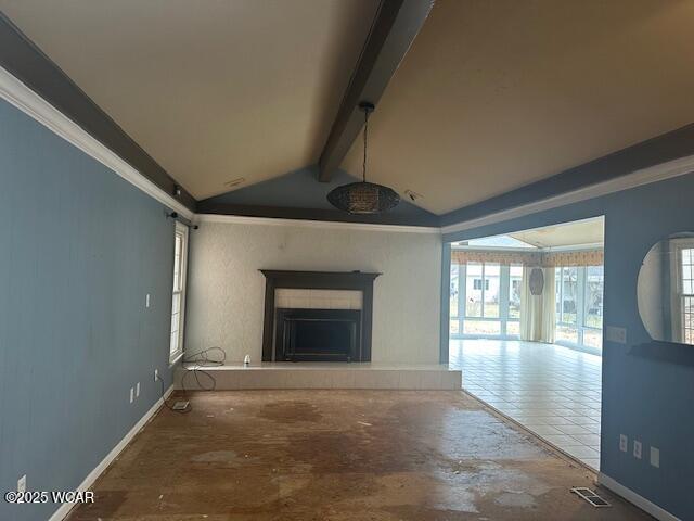 unfurnished living room featuring crown molding and lofted ceiling with beams