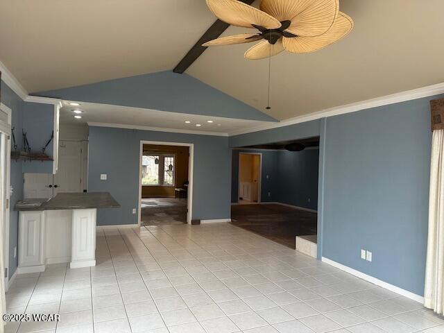 interior space with ceiling fan, crown molding, light tile patterned floors, and beam ceiling