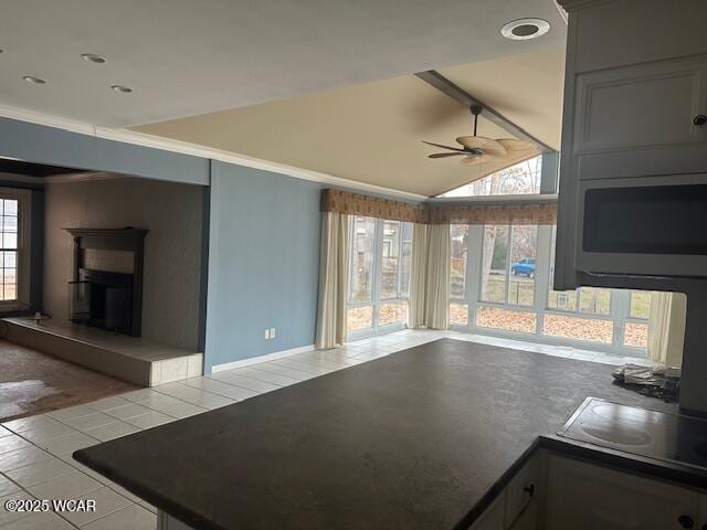 kitchen featuring lofted ceiling, light tile patterned floors, ceiling fan, gray cabinetry, and electric cooktop