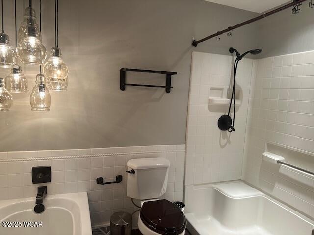 bathroom with tile walls and toilet