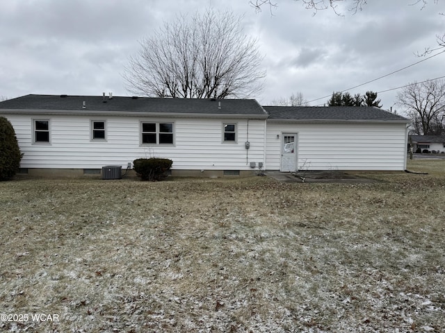 rear view of property with a yard and central AC