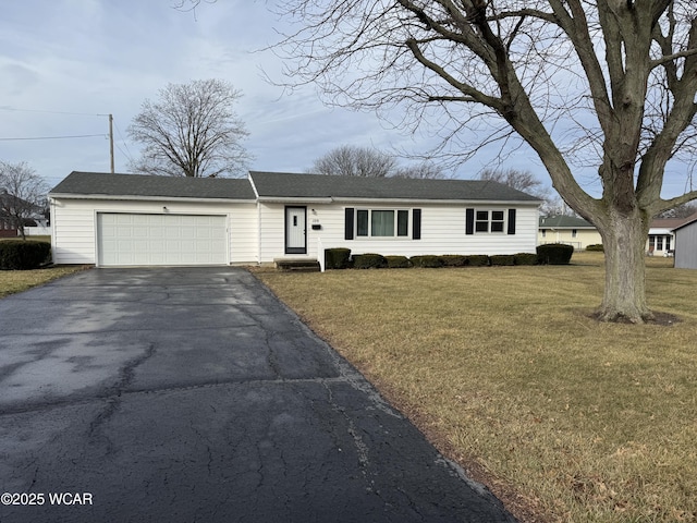 single story home featuring a garage and a front lawn