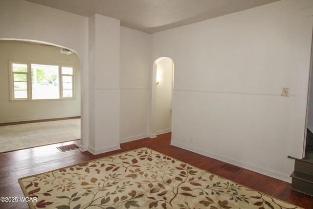 458 W Mckibben St, Lima, OH 45801 - spare room featuring arched walkways, wood finished floors, and baseboards