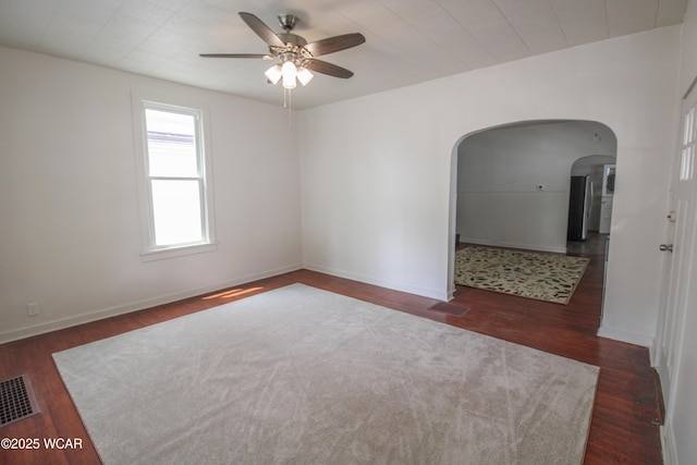 458 W Mckibben St, Lima, OH 45801 - spare room featuring arched walkways, a ceiling fan, wood finished floors, and baseboards