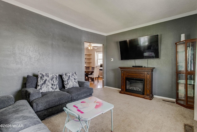 213 Johns Ave, Elida, OH 45807 - carpeted living room with ornamental molding, a textured wall, a glass covered fireplace, and baseboards