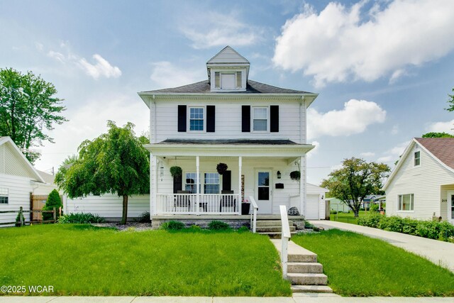 213 Johns Ave, Elida, OH 45807 - traditional style home featuring a porch, a front lawn, a garage, and concrete driveway