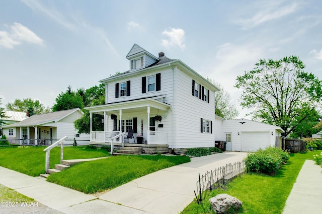 213 Johns Ave, Elida, OH 45807 - traditional style home with covered porch, driveway, and a garage