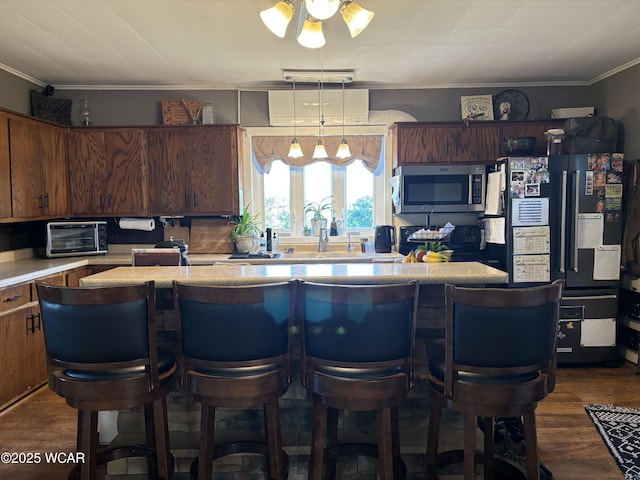 8989 Ridge Rd, Delphos, OH 45833 - kitchen with stainless steel microwave, fridge with ice dispenser, light countertops, ornamental molding, and dark wood finished floors