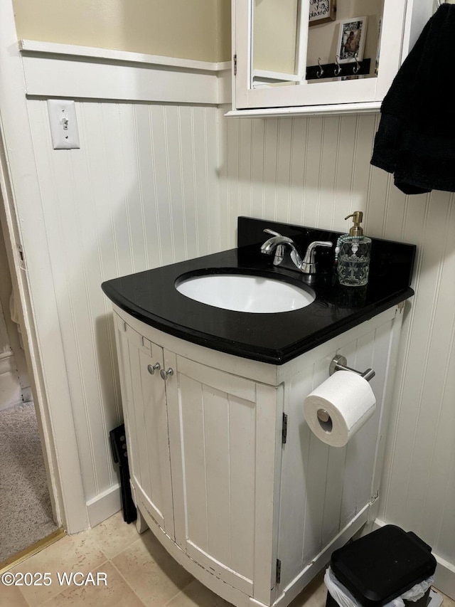 8989 Ridge Rd, Delphos, OH 45833 - bathroom featuring vanity, wainscoting, and a decorative wall