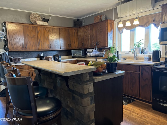 8989 Ridge Rd, Delphos, OH 45833 - kitchen featuring electric range, a sink, a center island, light countertops, and ornamental molding