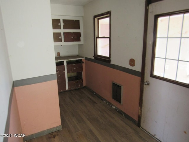 kitchen with a wealth of natural light, visible vents, and wood finished floors