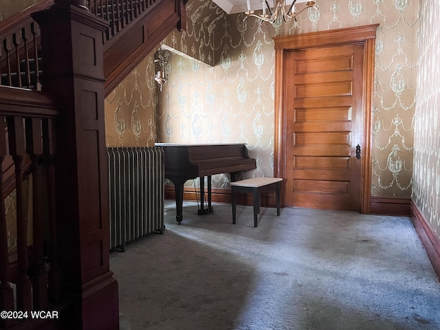 miscellaneous room featuring radiator and carpet