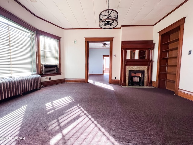 unfurnished living room featuring ornamental molding, carpet, radiator, and a fireplace