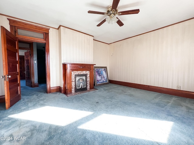 unfurnished living room with carpet floors, ornamental molding, and ceiling fan