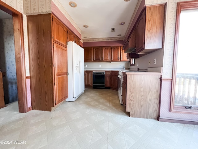 kitchen with white refrigerator with ice dispenser