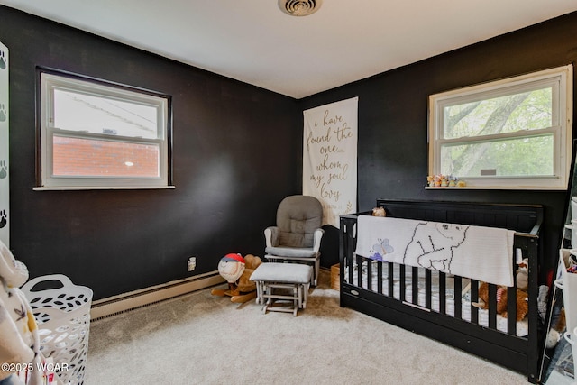 1153 Bahama Dr, Lima, OH 45801 - carpeted bedroom with a crib, visible vents, multiple windows, and a baseboard heating unit