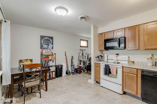 1153 Bahama Dr, Lima, OH 45801 - kitchen featuring light countertops, visible vents, and black appliances