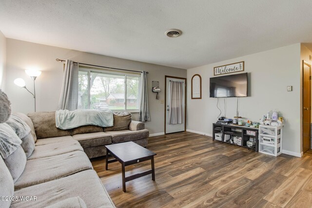 1153 Bahama Dr, Lima, OH 45801 - living room featuring baseboards, visible vents, and wood finished floors
