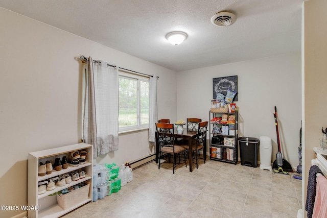 1153 Bahama Dr, Lima, OH 45801 - dining room with a textured ceiling, visible vents, and a baseboard radiator