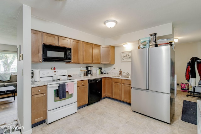 1153 Bahama Dr, Lima, OH 45801 - kitchen with light countertops, black appliances, and a sink
