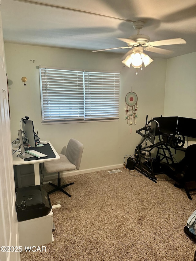 office area featuring visible vents, baseboards, a ceiling fan, and carpet flooring