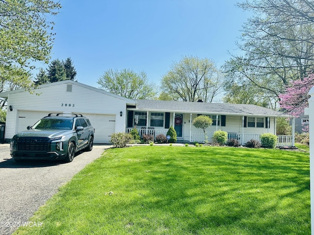 ranch-style home featuring a garage, driveway, a porch, and a front yard