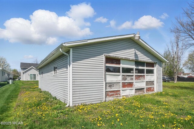 118 S Wagner Ave, Wapakoneta, OH 45895 - view of home's exterior featuring an outdoor structure, a detached garage, and a lawn
