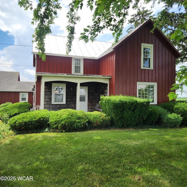 11205 Rd Z, Columbus Grove, OH 45830 - view of front of house featuring a front yard, a standing seam roof, and a metal roof