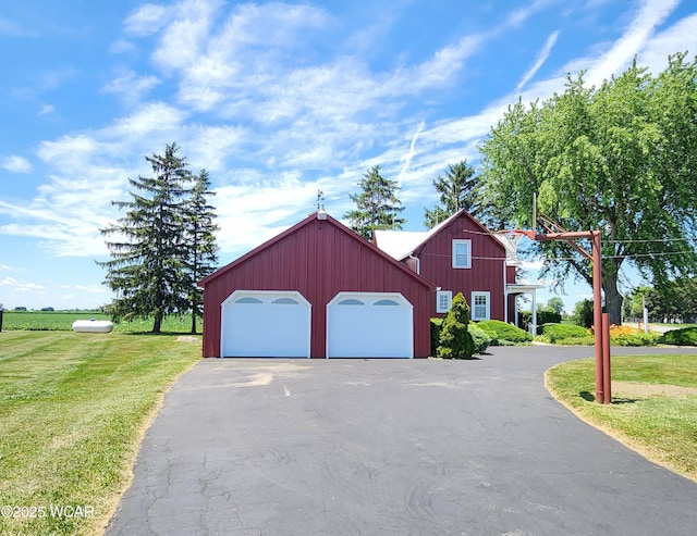 11205 Rd Z, Columbus Grove, OH 45830 - view of front facade with asphalt driveway, an attached garage, and a front yard