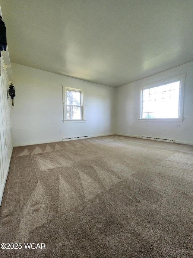 11205 Rd Z, Columbus Grove, OH 45830 - carpeted empty room featuring a baseboard radiator, healthy amount of natural light, and baseboard heating