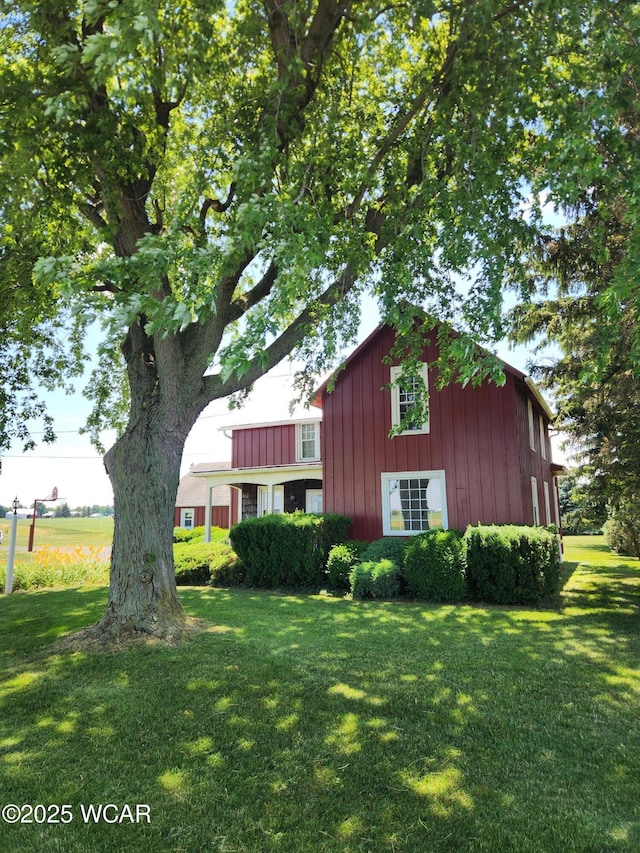 11205 Rd Z, Columbus Grove, OH 45830 - view of home's exterior with a lawn and board and batten siding