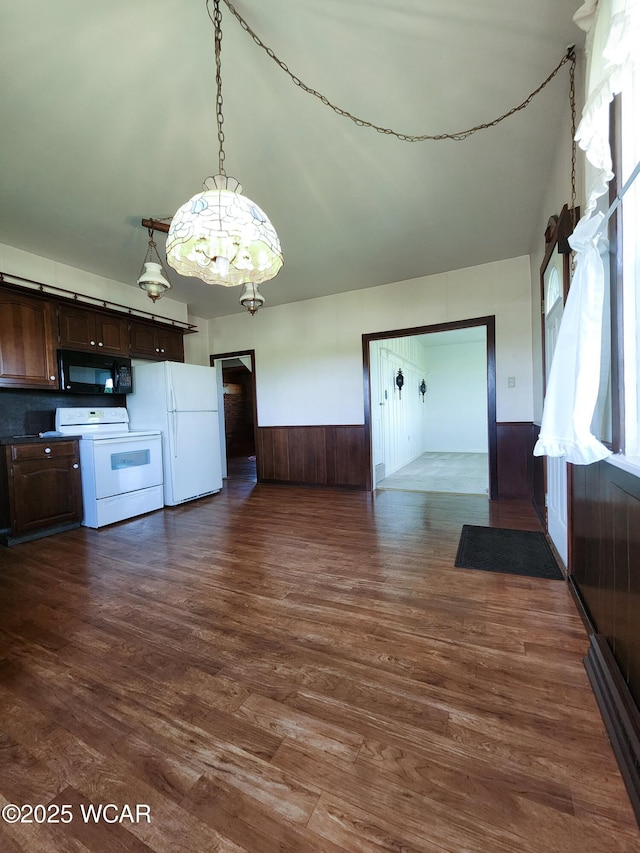 11205 Rd Z, Columbus Grove, OH 45830 - kitchen with white appliances, dark brown cabinetry, open floor plan, dark wood finished floors, and a wainscoted wall
