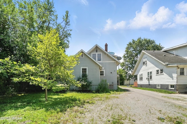 513 Gordon Ave, Van Wert, OH 45891 - rear view of property featuring driveway and a chimney